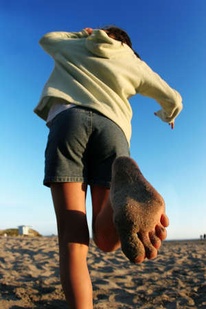 Girl running on the beachの写真素材