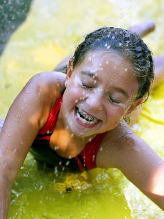 Hapyy girl on a water slideの写真素材