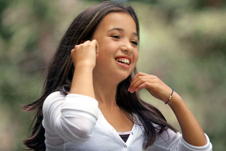 Girl playing with her hairの写真素材