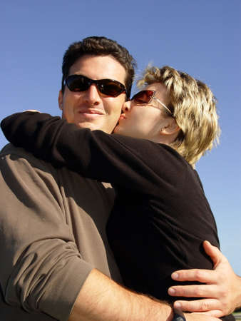 Couple kissing under the sun