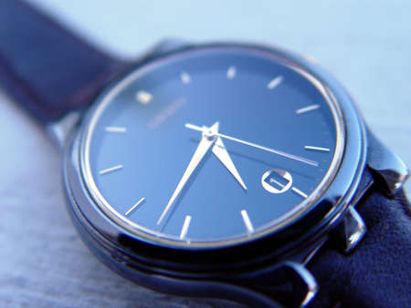Close up of a blue watch with focus on hands and calendarの写真素材