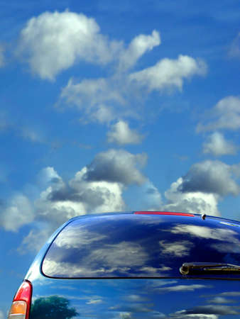 Blue sky and clouds reflected in the carの写真素材