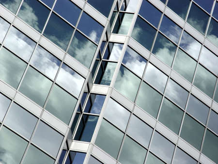 Blue sky and clouds reflected in the glass building in downtown Toronto