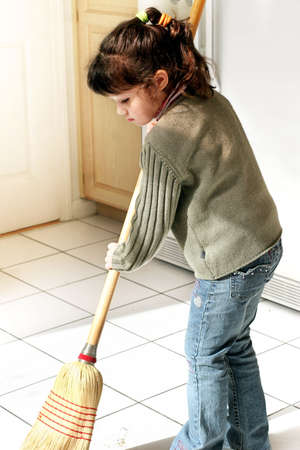 Little girl helping to clean the houseの写真素材
