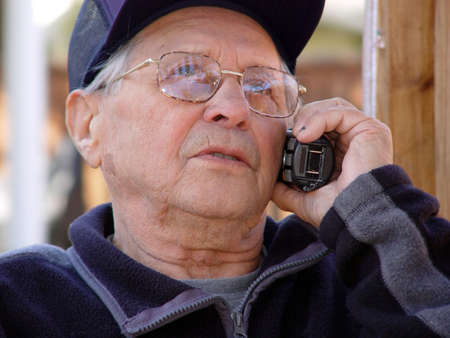 An old man talking on the phone