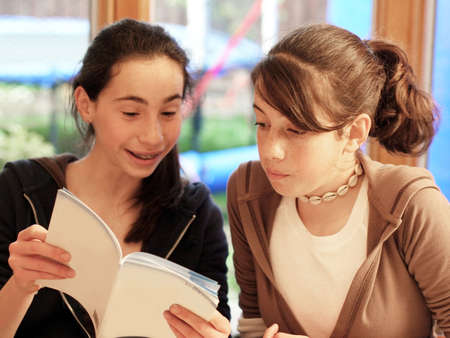 Teenage girls reading a book