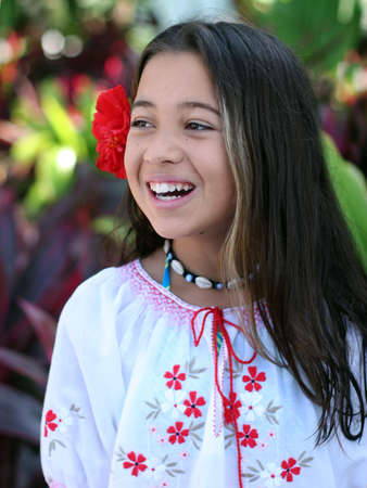 Smiling girl in a tropical gardenの写真素材