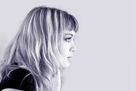 Profile of a young blond girlの写真素材