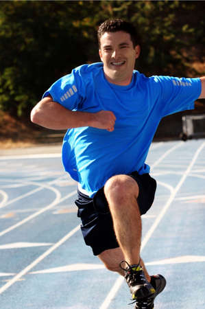 Man running  on a blue racetrack