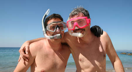 Two men are about to go snorkeling in the oceanの写真素材