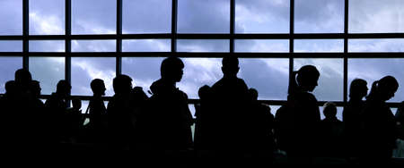 People waiting in line at the airport silhouetteの写真素材