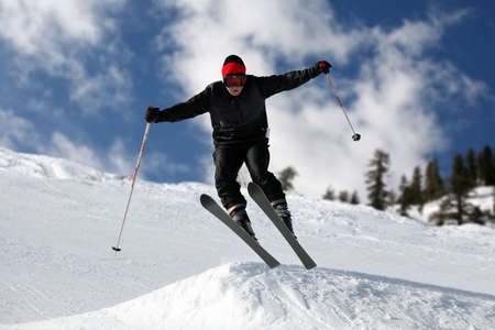 Skier on a slope against the cloudy skyの写真素材