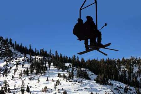 Two people on the lift at the ski resortの写真素材