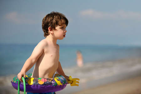 Little boy with toys on the beachの写真素材