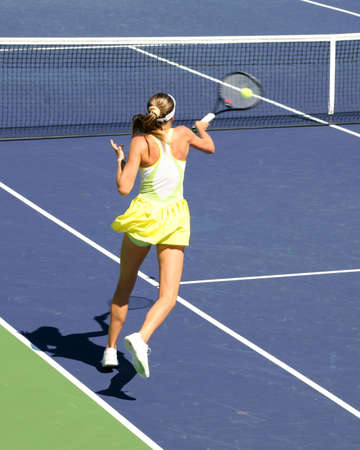 Woman playing tennis at the professional tournamentの写真素材