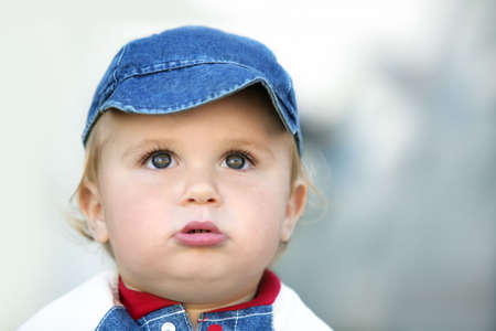 Cute happy 14 month old baby in a hatの写真素材