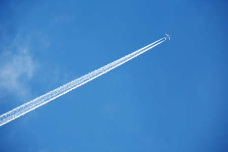 An airplane trail across the skyの写真素材