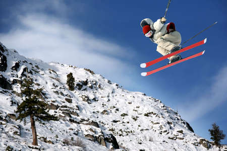 A young man jumping high at Lake Tahoe resortの写真素材