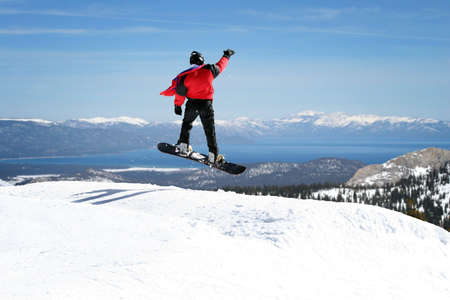 Snowboarder enjoying a view at Lake Tahoe, Californiaの写真素材