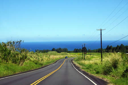 Lonely car on the road on Big Island, Hawaiiの写真素材