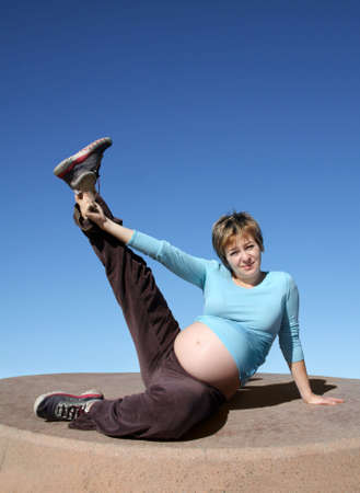 A Pregnant young woman exercising outdoors