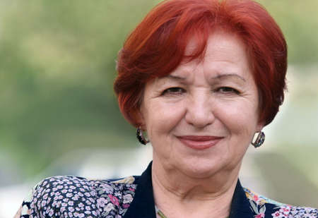 Portrait of a smiling woman in her seventiesの写真素材