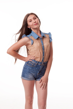 Beautiful girl dancing in the camera, posing against white background. Different poses and emotions. Standing, moving, smiling. playful dances, choreography. Brunette with long hair, slender, cheerful and charismaticの写真素材