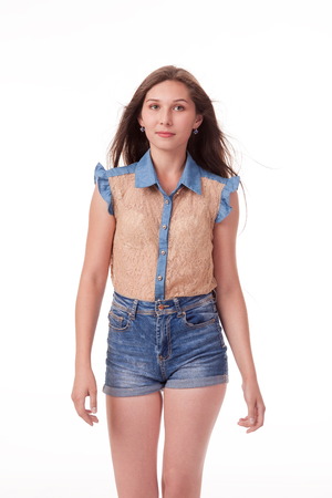 Beautiful girl dancing in the camera, posing against white background. Different poses and emotions. Standing, moving, smiling. playful dances, choreography. Brunette with long hair, slender, cheerful and charismaticの写真素材