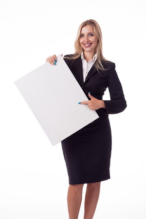 Blonde with long hair posing with white plate, pattern. For logo, advertising. Isolated photo on a white background for advertising. In a business black suit.の写真素材