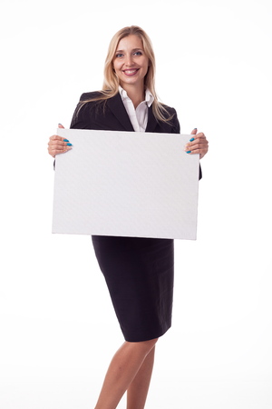 Blonde with long hair posing with white plate, pattern. For logo, advertising. Isolated photo on a white background for advertising. In a business black suit.の写真素材