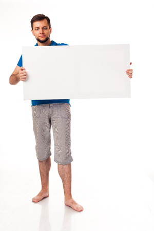 A guy with a beard posing with a white sign, isolated on a white background.の写真素材