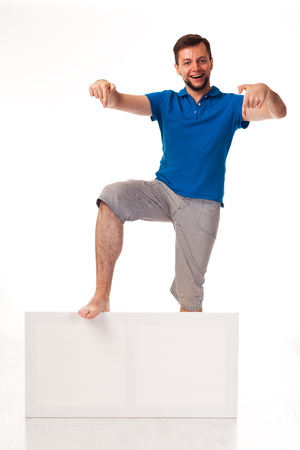A guy with a beard posing with a white sign, isolated on a white background.の写真素材