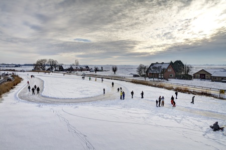 Ouderkerk aan de Amstel, the Netherlands, February 2, 2012 - Skaters on cleared skating rink with...