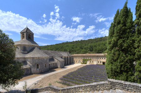 Side view of  medieval Senanque abbey, a Cistercian abbey near Gordes in Provence, France,w ith blossoming lavender fieldのeditorial素材