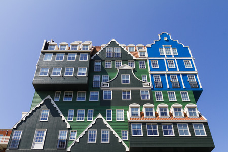 Multiple facades of typical Dutch wooden green gable houses in contemporary hotel architectureのeditorial素材
