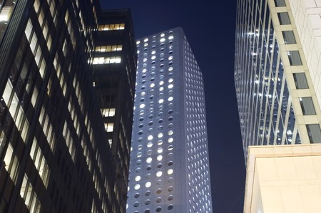 Hongkong city center by night. Modern skyscrapers, office buildings surrounding street in Central...