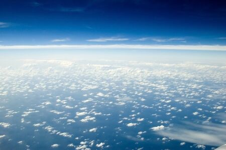 Beautiful skyscape over Indian Ocean. Blue sky with many single clouds below, just above ocean...
