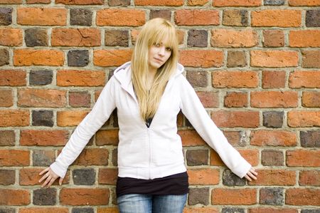 Young, pretty and kind teenage girl in Poland. Schoolgirl with casual clothes, blonde hairs. Peaceful and calm face expression.の写真素材