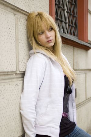 Young, pretty and kind teenage girl in Poland. Schoolgirl with casual clothes, blonde hairs. Peaceful and calm face expression.の写真素材