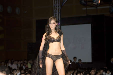 CHINA, SHENZHEN, GUANGDONG PROVINCE - APRIL 5, 2009:  The Fourth Shenzhen International Brand Underwear Fair with fashion show. Female and male models presents underwear and sexy costumes.のeditorial素材