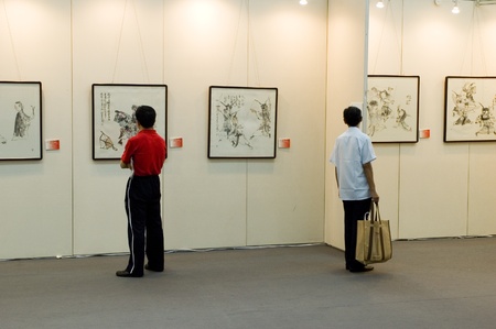 CHINA, GUANGDONG, SHENZHEN - MAY 16, 2009: China International Cultural Industries Fair, visitors watching modern and ancient art, Chinese paintings and graphics made in ink.のeditorial素材