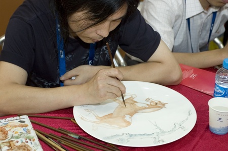 CHINA, GUANGDONG, SHENZHEN - MAY 17, 2009: China International Cultural Industries Fair: hand painting porcelain plate.のeditorial素材