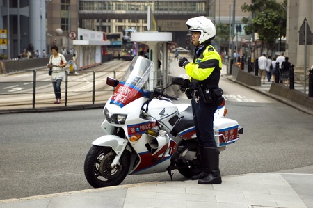 HONG KONG - OCTOBER 30: Policeman in Hong Kong preparing to patrol city center by motorcycle on October 30, 2008 in Hong Kong.のeditorial素材
