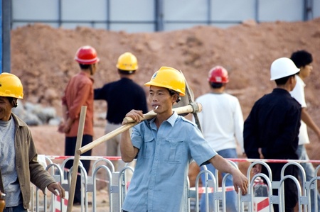 CHINA, SHENZHEN - NOVEMBER 24: Workers from all around China are building Shenzhen metro, group of workers having break for cigarettes on October 24, 2008 in Shenzhen, China.のeditorial素材