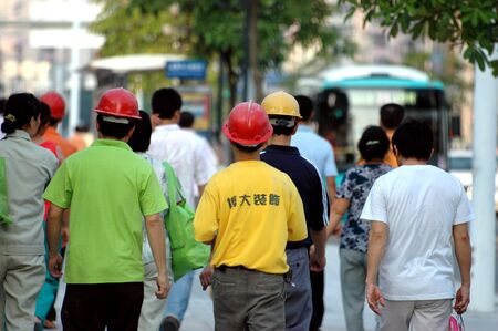 CHINA, SHENZHEN - JULY 17: Chinese workers in moder city are constructing  new skyscrapers, group of workers going back for dinner on July 17, 2008 in Shenzhen, China.のeditorial素材