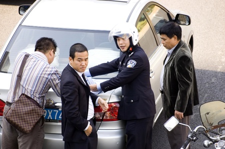 CHINA, SHENZHEN - DECEMBER 9: Policeman resolving car accident in Chinese city, even there are more and more cars in China, driving skills are getting worse, accident on December 9, 2008 in Shenzhen, China.のeditorial素材