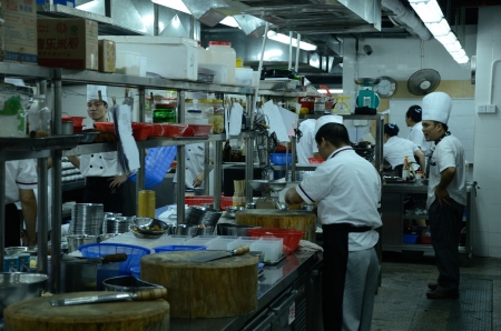 SHENZHEN, CHINA - SEPTEMBER 8: Unidentified Chinese chefs work in kitchen, inside Cantonese style restaurant in Nanshan district on September 8, 2012.のeditorial素材