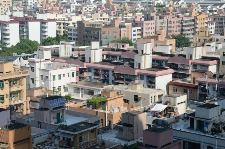 SHENZHEN, CHINA - SEPTEMBER 16:  Modern Shenzhen city, Futian district with old residential buildings on September 16, 2012. Within few years old houses will be replaced with modern skyscrapers.のeditorial素材