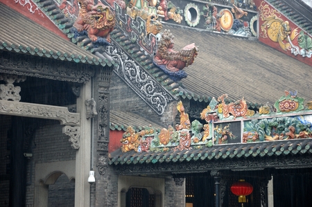 Historical roofs inside Chen Family Temple in Guangzhou, China. Roofs and colums with colorful decorations.のeditorial素材