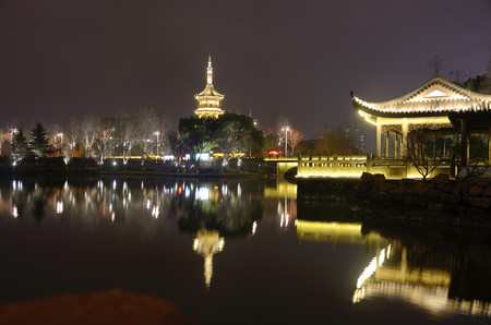 Jiaxing, Zhejiang province in China. Illuminated traditional buildings, temple and pagoda with...